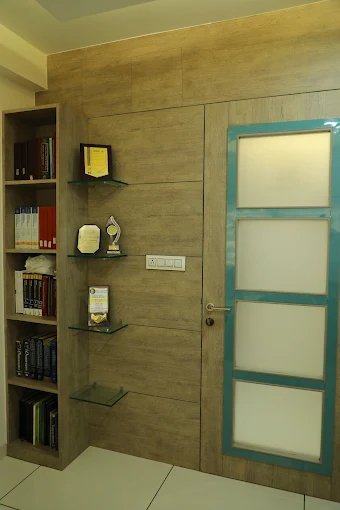 A neat and professional office corner displaying books, certificates, and awards, contributing to the welcoming atmosphere.
