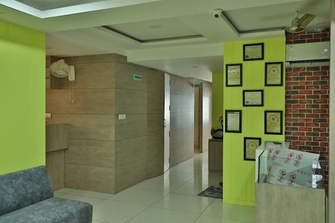 The bright and welcoming reception area of a clinic, featuring framed certificates, comfortable seating, and a clean, professional environment.